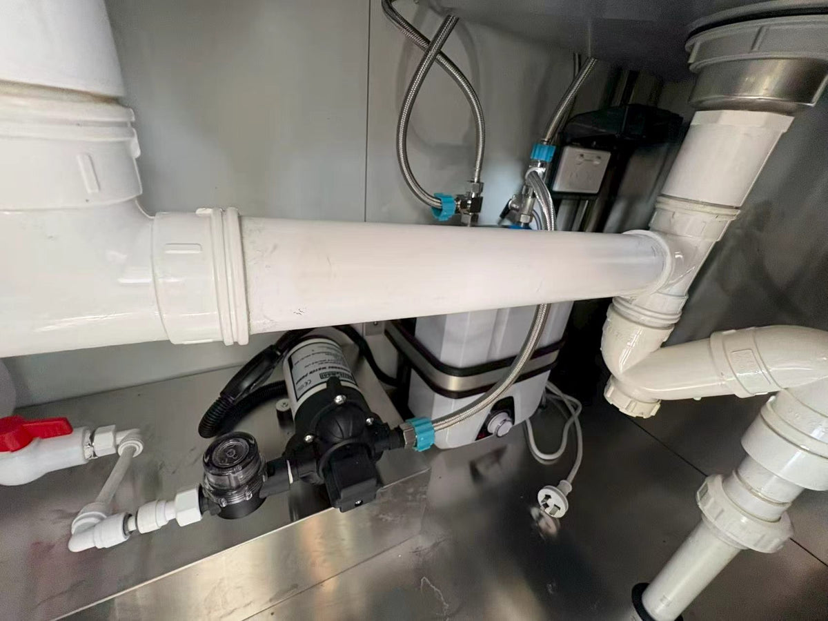 Original photograph of plumbing and equipment beneath the 3m trailer sinks